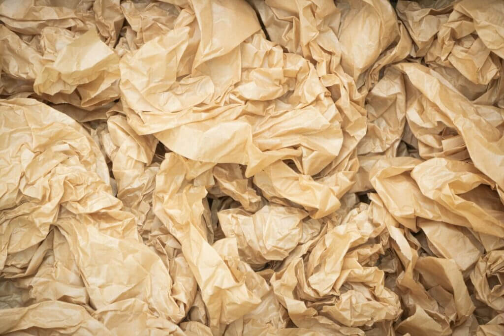 Close-up view of crumpled brown paper texture for design backgrounds or concepts.